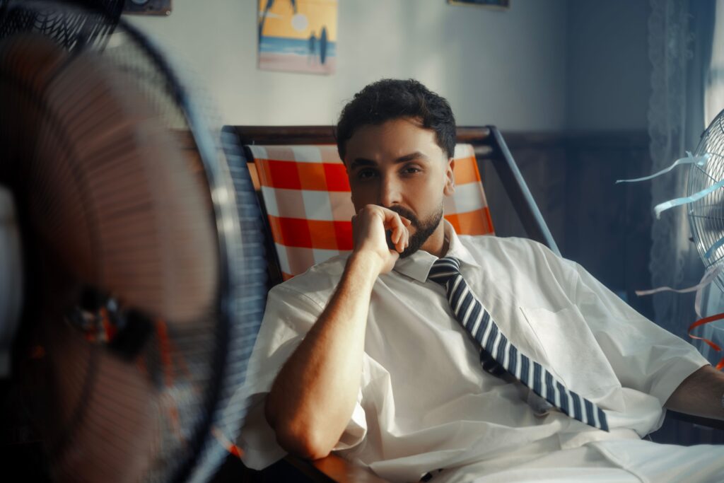 An overheated man trying to stay cool in his home